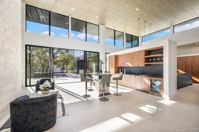 a living room with furniture and view of kitchen