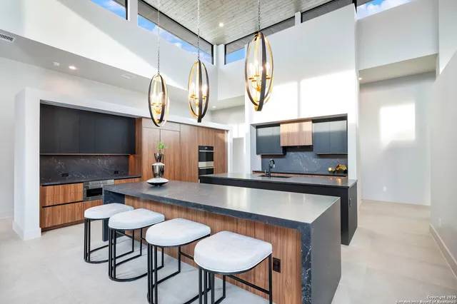 a kitchen with stainless steel appliances granite countertop a sink and a refrigerator