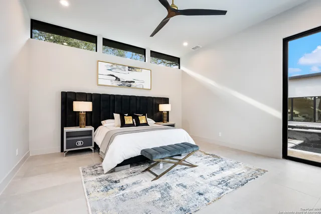 a bedroom with a bed window and couch