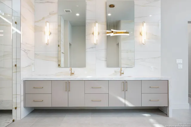 a bathroom with a double vanity sink toilet and shower