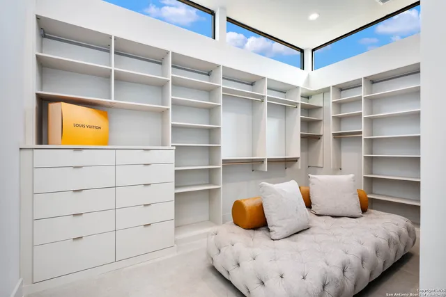 a view of walk in closet with empty racks