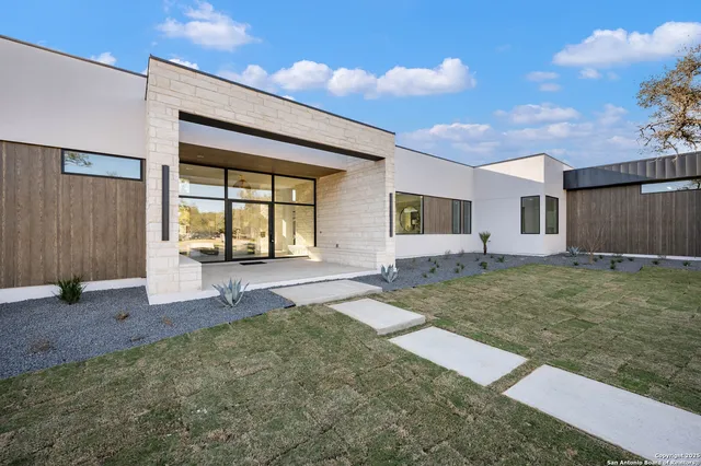 a view of a dinning table and chairs in patio of the house