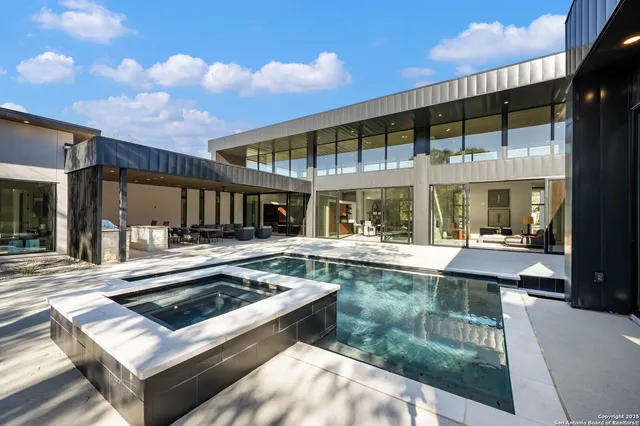 a living room with stainless steel appliances granite countertop a sink and stove
