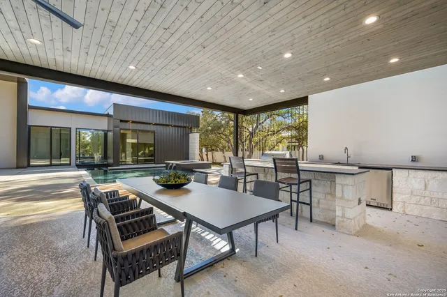 a view of a dining table and chairs in the patio