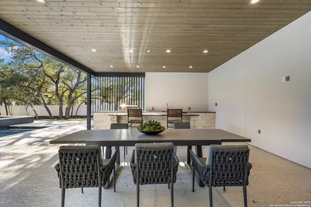 a kitchen with a table chairs and wooden floor