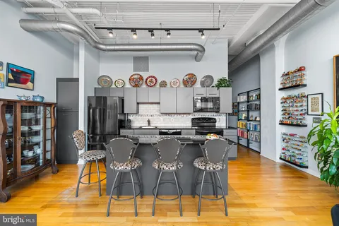 a view of a dining room with furniture a chandelier and wooden floor