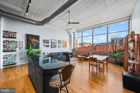 a living room with furniture a rug and a window