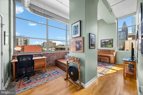 a living room with furniture and a piano