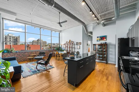 a living room with furniture and a floor to ceiling window