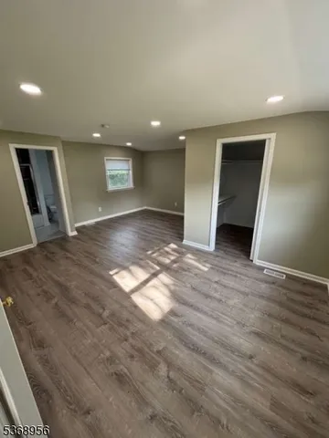 a kitchen with a refrigerator stove and wooden cabinets