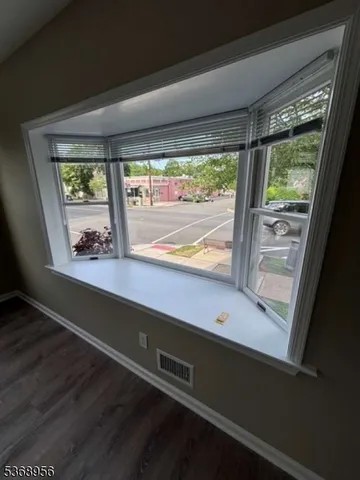 an empty room with wooden floor and closet