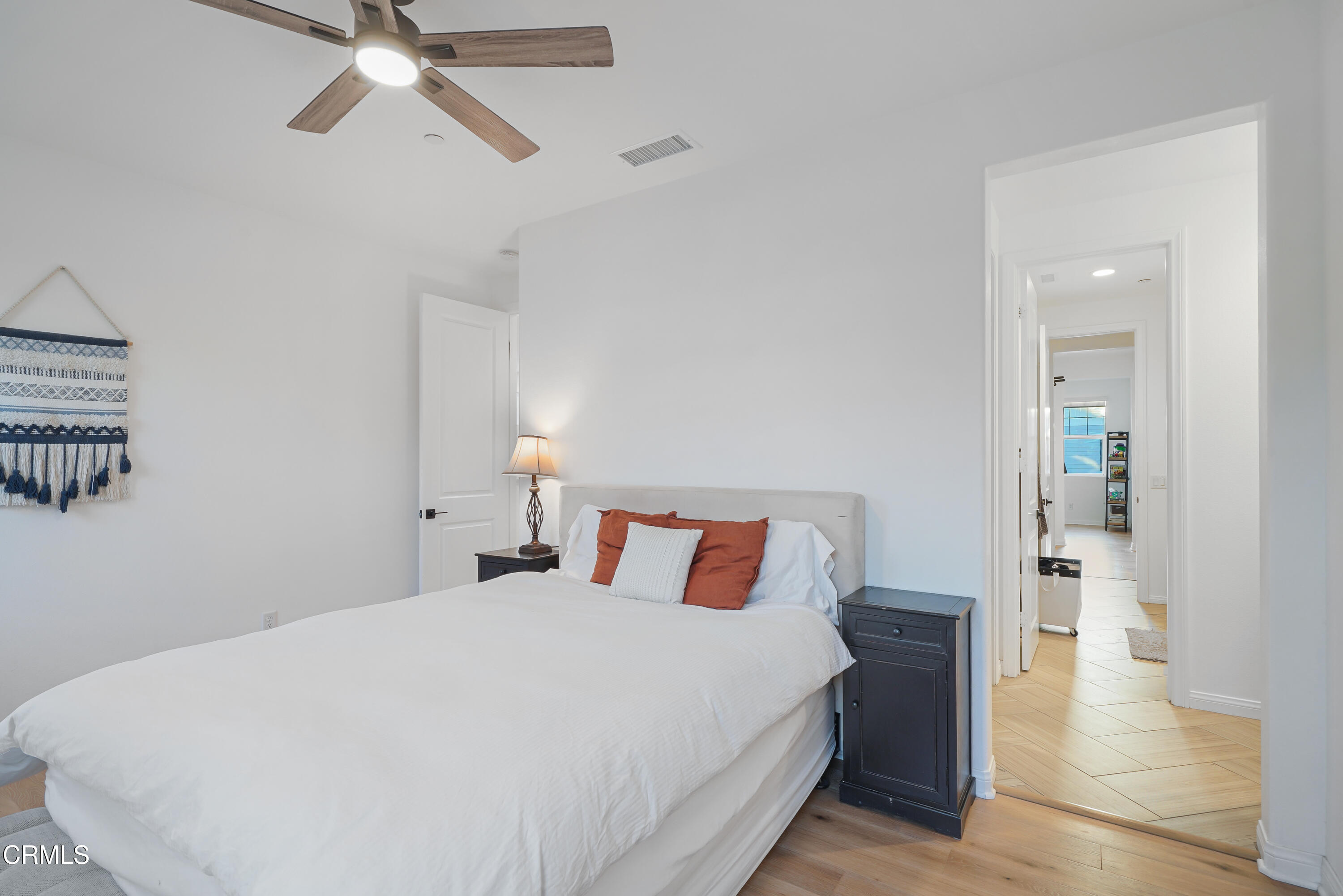 263 Wisteria Street Fillmore, CA 93015 - Photo 18 of 51 a bedroom with a large bed and a chandelier