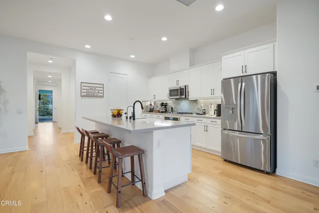 a spacious bedroom with a bed and a large window
