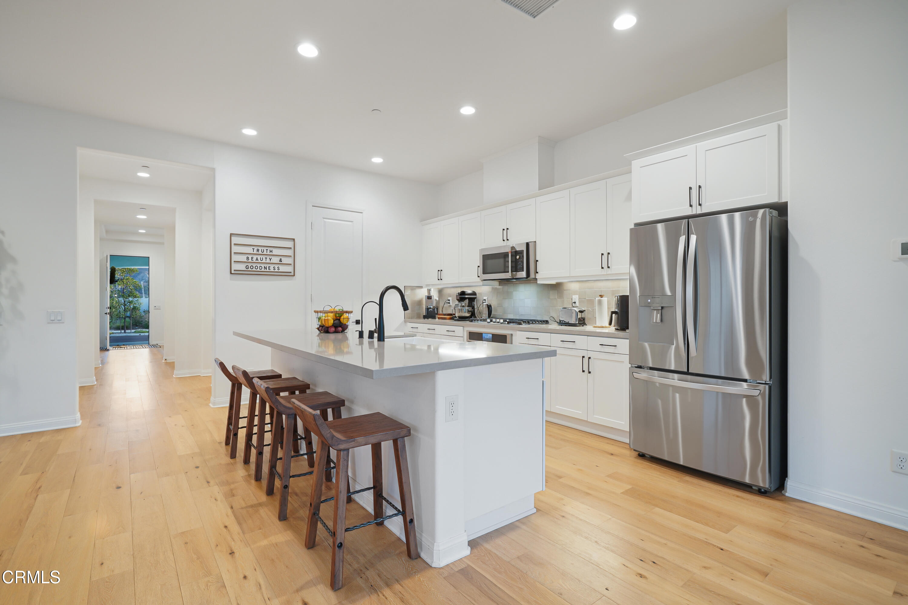 263 Wisteria Street Fillmore, CA 93015 - Photo 30 of 51 a kitchen with stainless steel appliances a refrigerator a stove a sink a dining table and chairs