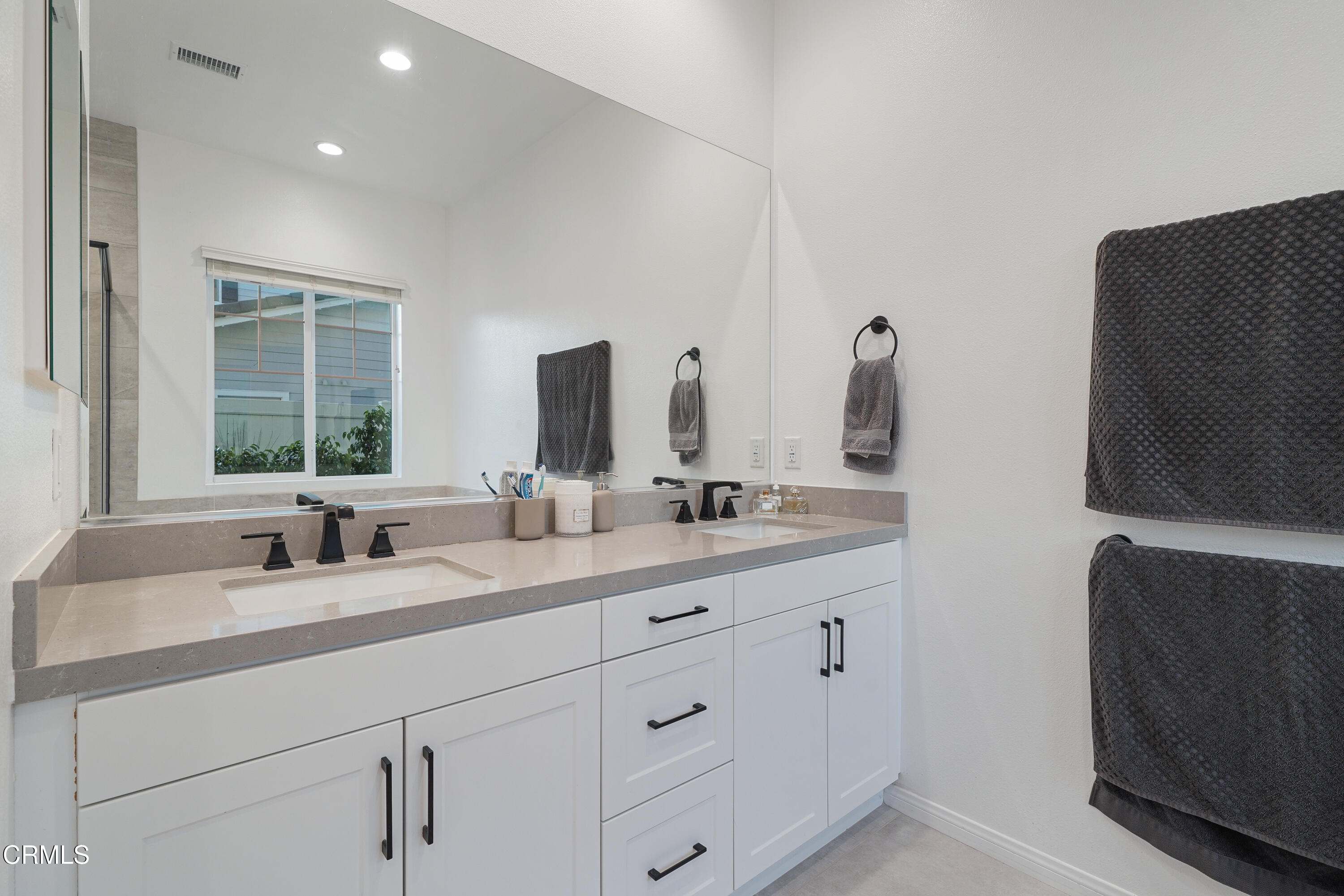 263 Wisteria Street Fillmore, CA 93015 - Photo 34 of 51 a bathroom with a double vanity sink and mirror