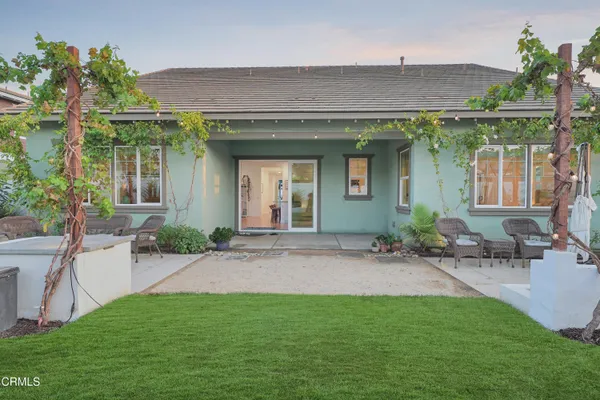 a view of a house with a yard and a patio