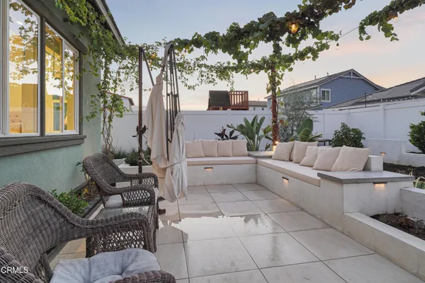 a building outdoor space with patio furniture and potted plants