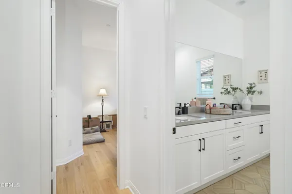 a bathroom with double vanity and a mirror