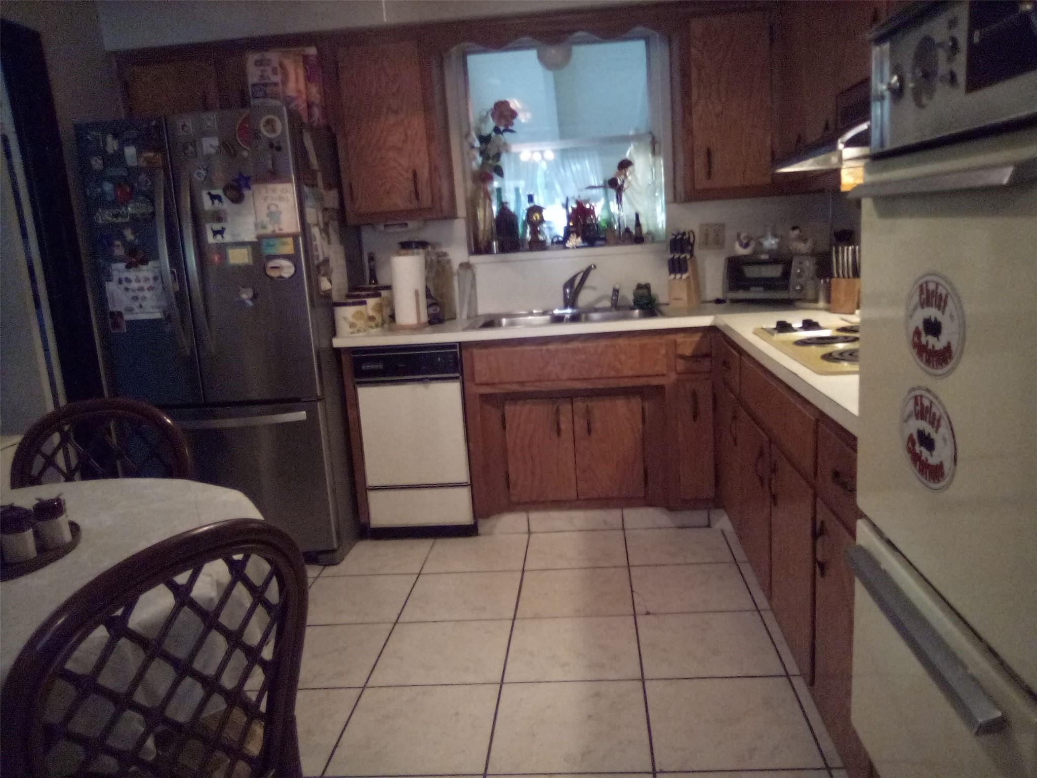 3401 West Park Road Hollywood, FL 33021 - Photo 19 of 28 a kitchen with a sink a refrigerator and cabinets