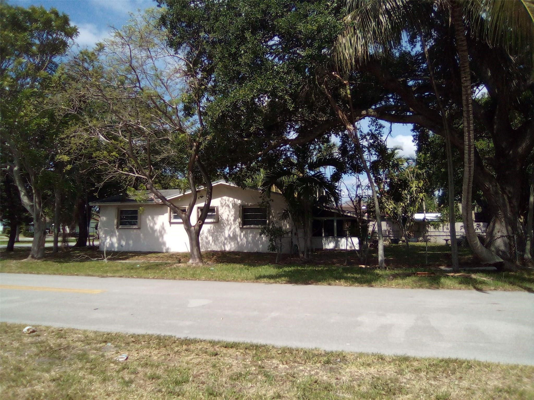 3401 West Park Road Hollywood, FL 33021 - Photo 3 of 28 a view of a house with a yard and large tree