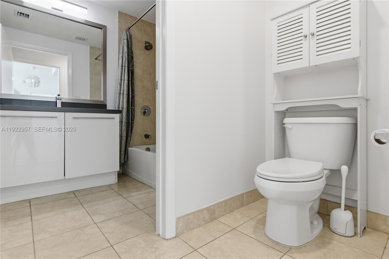 90 Southwest 3rd Street, Unit 2408 Miami, FL 33130 - Photo 12 of 28 a bathroom with a toilet sink and mirror
