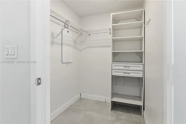 a view of walk in closet with empty racks