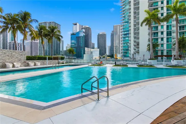 a swimming pool with outdoor seating and yard