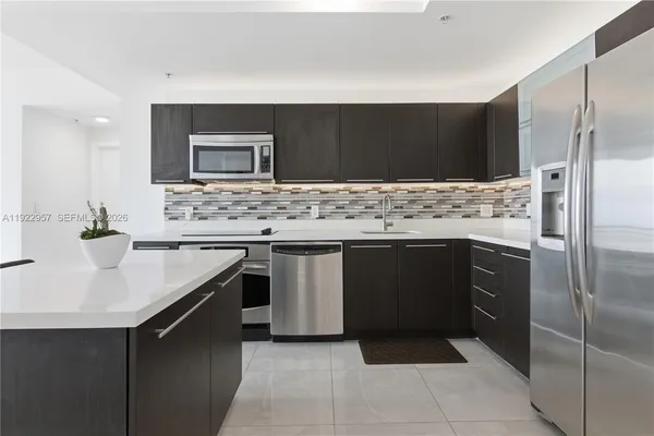 a kitchen with a sink stove and refrigerator