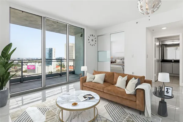 a living room with furniture and a large window