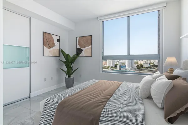 a bedroom with a large bed and a window