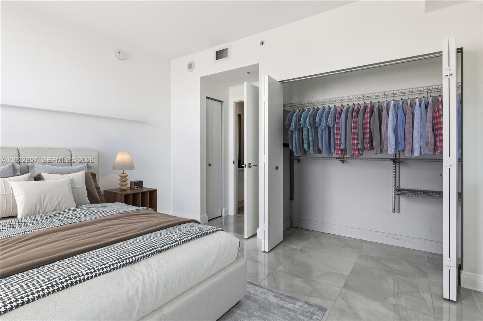 90 Southwest 3rd Street, Unit 2408 Miami, FL 33130 - Photo 9 of 28 a bedroom with a bed and a refrigerator