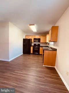 a view of a kitchen with wooden floor