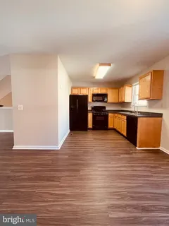a large kitchen with stainless steel appliances granite countertop a stove and a refrigerator