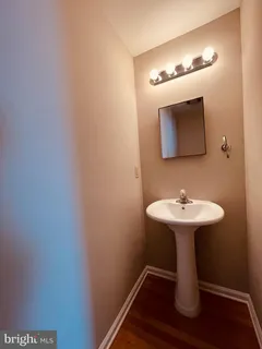 a bathroom with a sink toilet and mirror