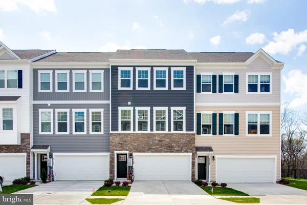 a front view of a residential apartment building with a yard