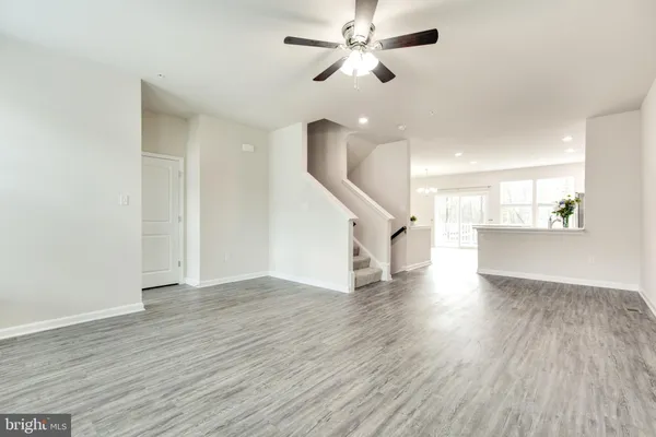 a view of a kitchen with wooden floor and electronic appliances