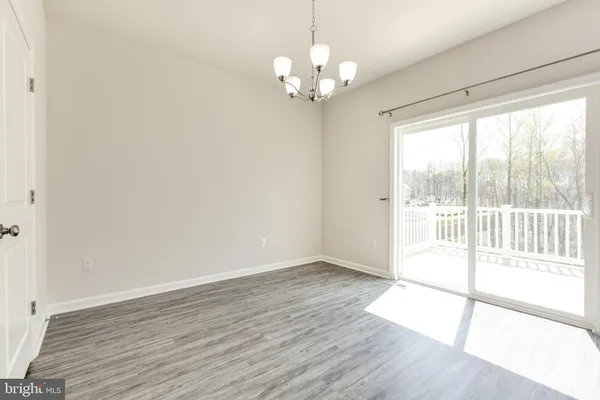 a kitchen with stainless steel appliances white cabinets and a refrigerator