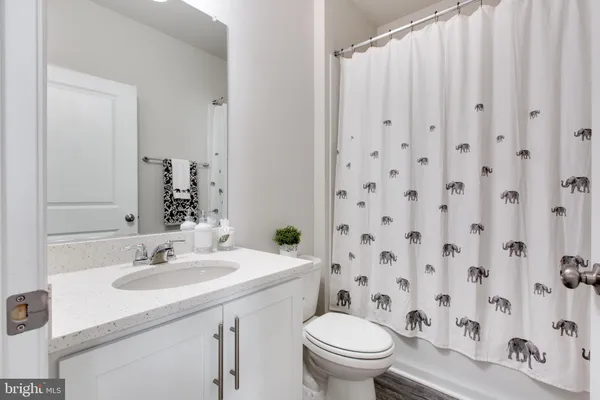 an entryway with a cabinet and a bathroom