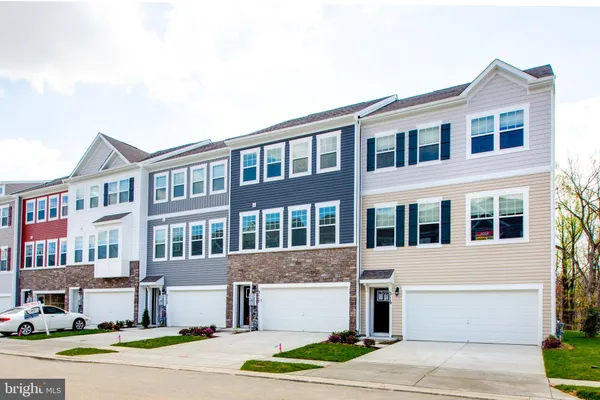 a front view of a residential apartment building with a yard