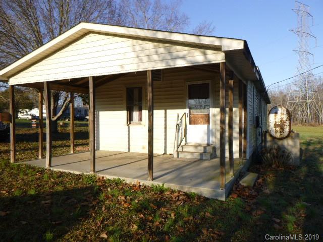 6506 Helms And Belk Road Monroe, NC 28110 - Photo 3 of 16 a backyard of a house with table and chairs