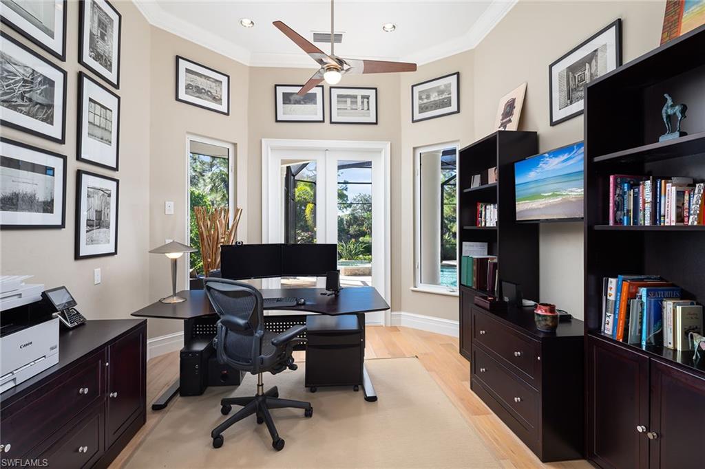 11617 Useppa Court Naples, FL 34110 - Photo 21 of 50 a view of a workspace with bookshelf and a window