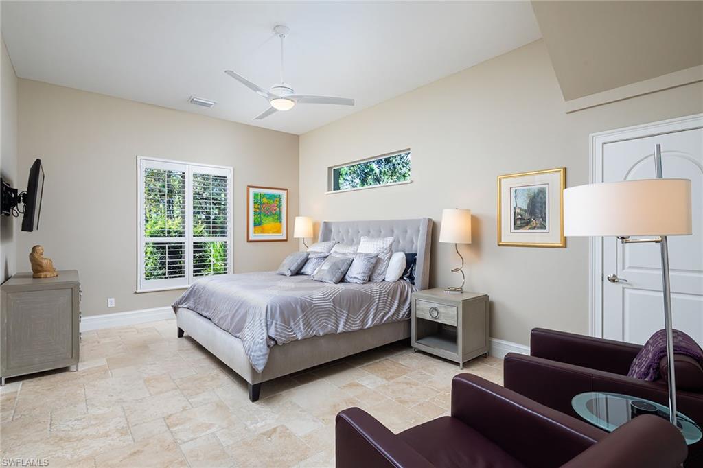 11617 Useppa Court Naples, FL 34110 - Photo 23 of 50 a spacious bedroom with a bed couch and a window