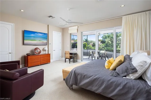 a spacious bedroom with a bed and a large window