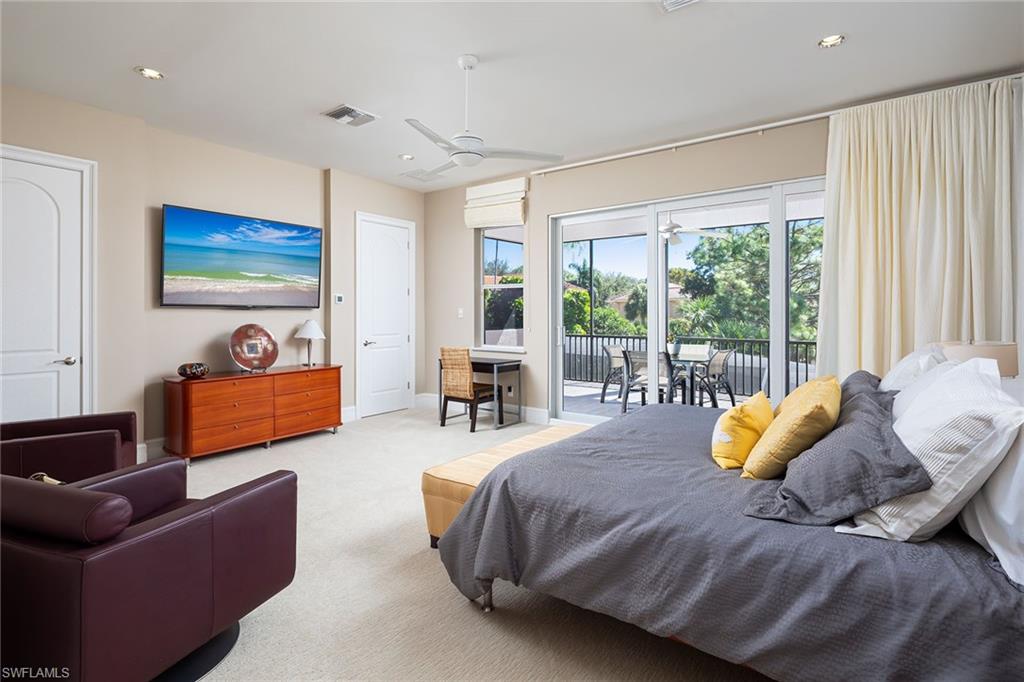 11617 Useppa Court Naples, FL 34110 - Photo 26 of 50 a bedroom with bed and glass window