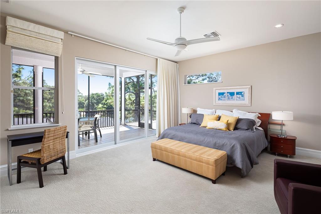11617 Useppa Court Naples, FL 34110 - Photo 27 of 50 a spacious bedroom with a bed and a large window