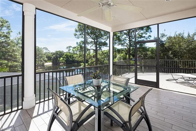 a view of a balcony with lake view and a potted plant