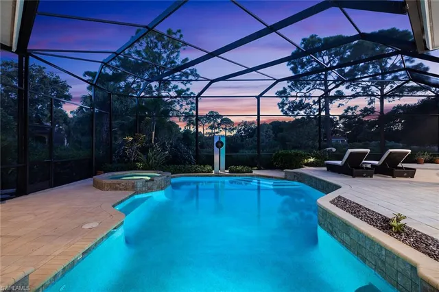 a view of a patio with table and chairs under an umbrella