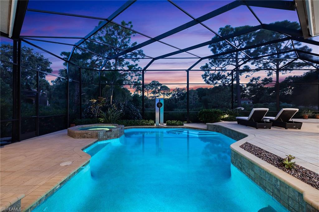 11617 Useppa Court Naples, FL 34110 - Photo 34 of 50 a view of a swimming pool with a patio