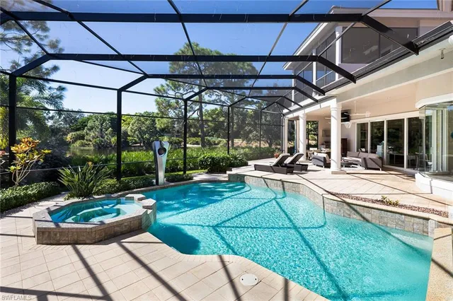a view of a patio with couches table and chairs under an umbrella