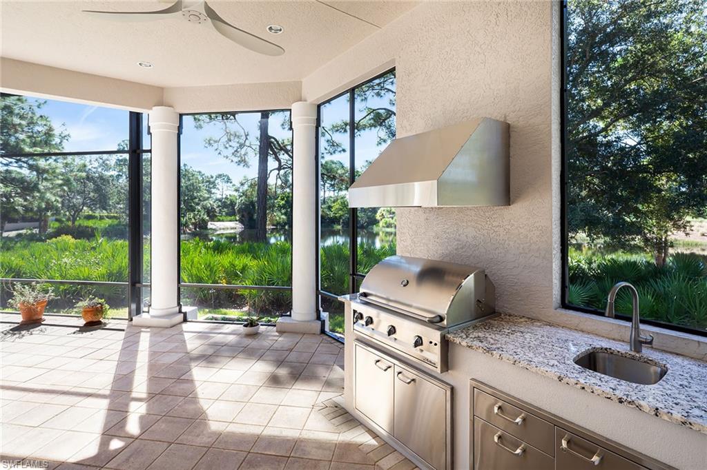 11617 Useppa Court Naples, FL 34110 - Photo 40 of 50 a open kitchen with stainless steel appliances granite countertop a barbecue grill and view of living room